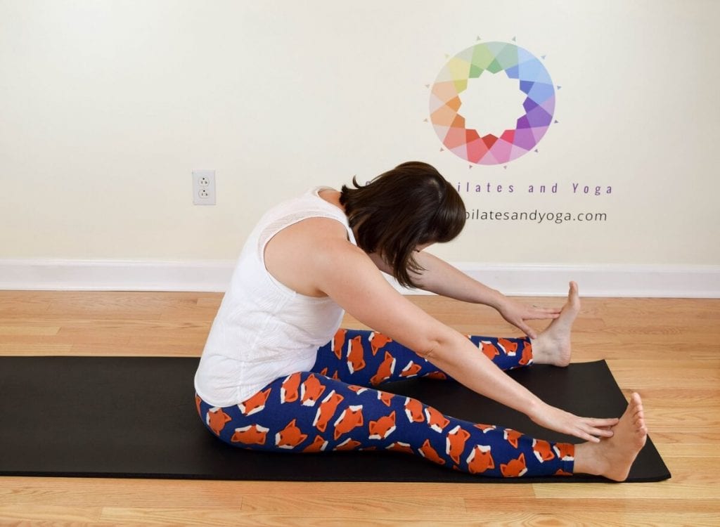 sarah stockett doing pilates spine stretch forward